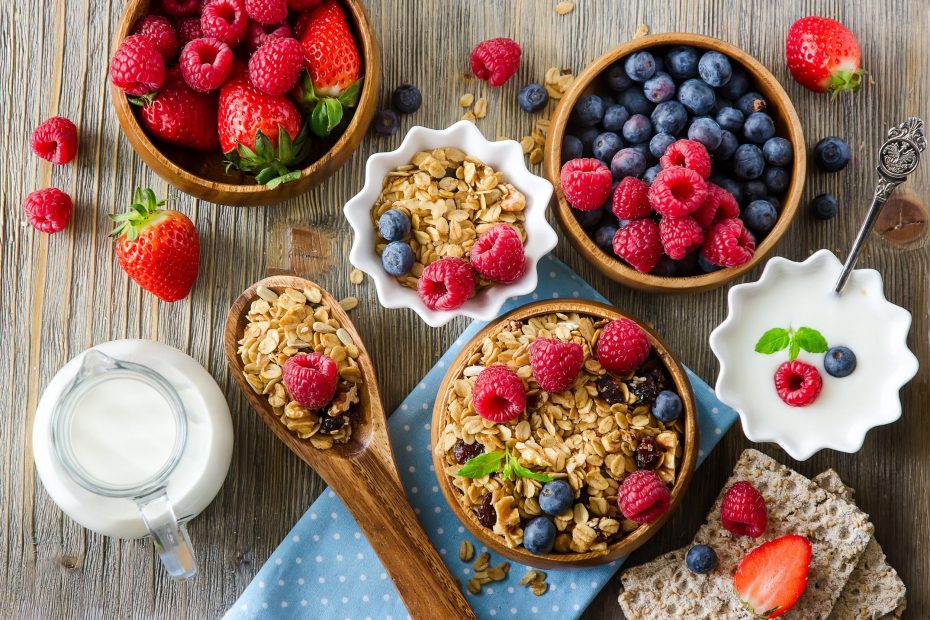 54942662 - healthy breakfast, muesli, raspberries, blueberries, strawberries, crisp bread and yogurt, health and diet concept